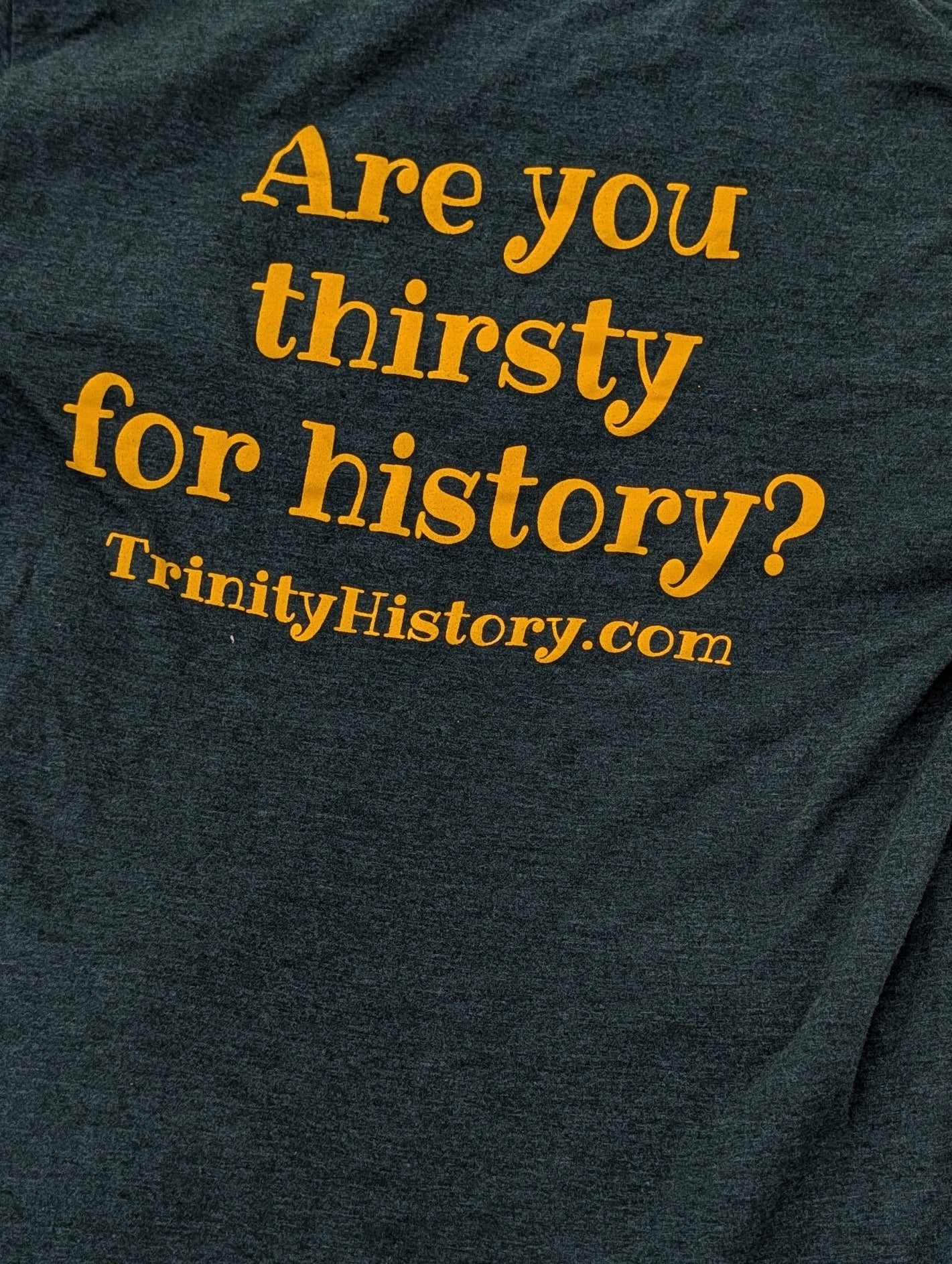 Dark green shirt with gold letters